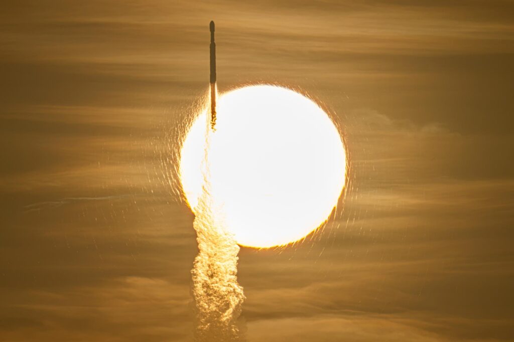 NASA's Roman Space Telescope launches aboard a Falcon Heavy rocket in front of the Sun