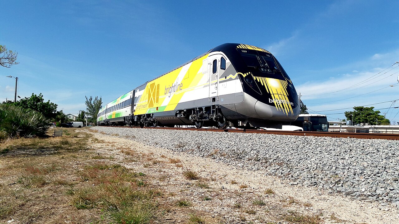 Brightline passenger train traveling on Florida tracks